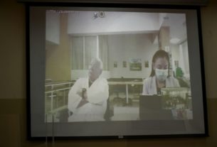 O general reformado Benedicto Lucas García (91) aparece em um telão durante uma videochamada de sua audiência, do quarto de um hospital militar onde está detido na Cidade da Guatemala, em 5 de abril de 2024 - AFP